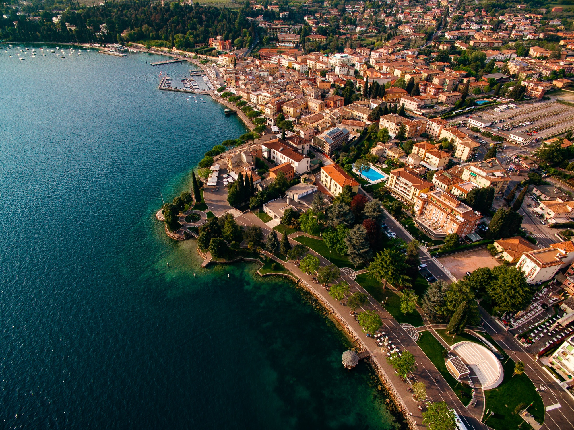 Aerial view of the coast of Lake Garda and a city in Italy.