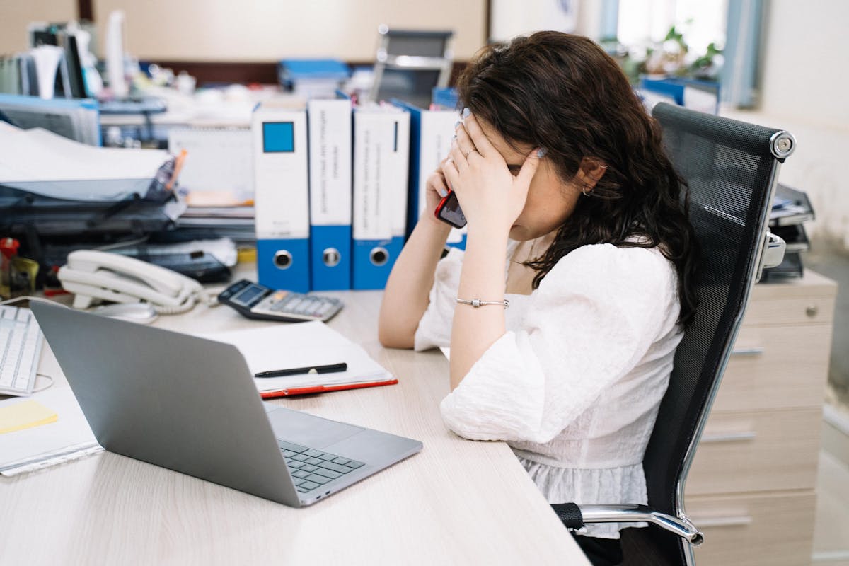 Office scene with paperwork and laptop addressing nonprofit organization compliance issues.