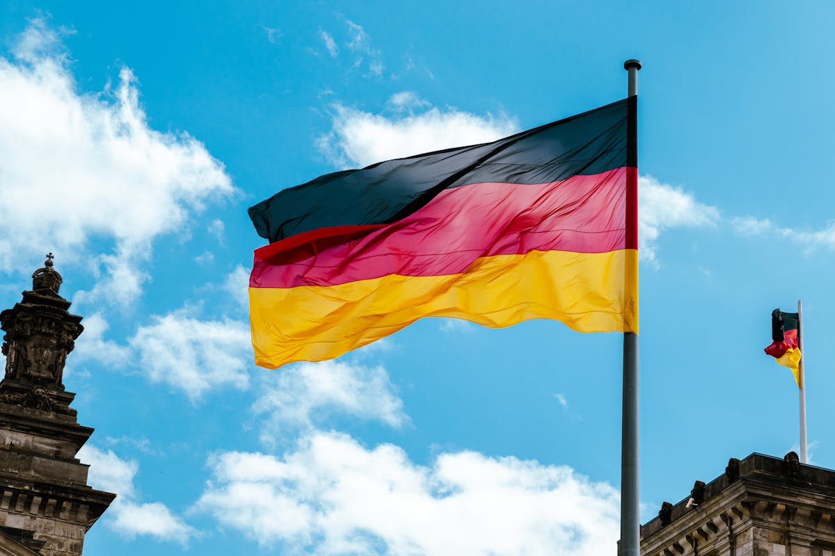 Retire in Germany as an American shown by the German flag billowing beside a civic building.