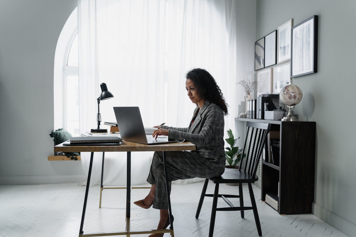 Guide to self-employed tax calculator 2025 shown by a focused professional typing at a desk.