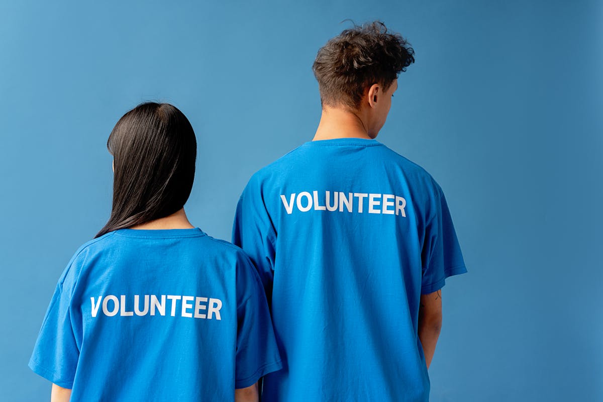 Guide to state filing for nonprofits 2025 shown by two volunteers in branded blue shirts.