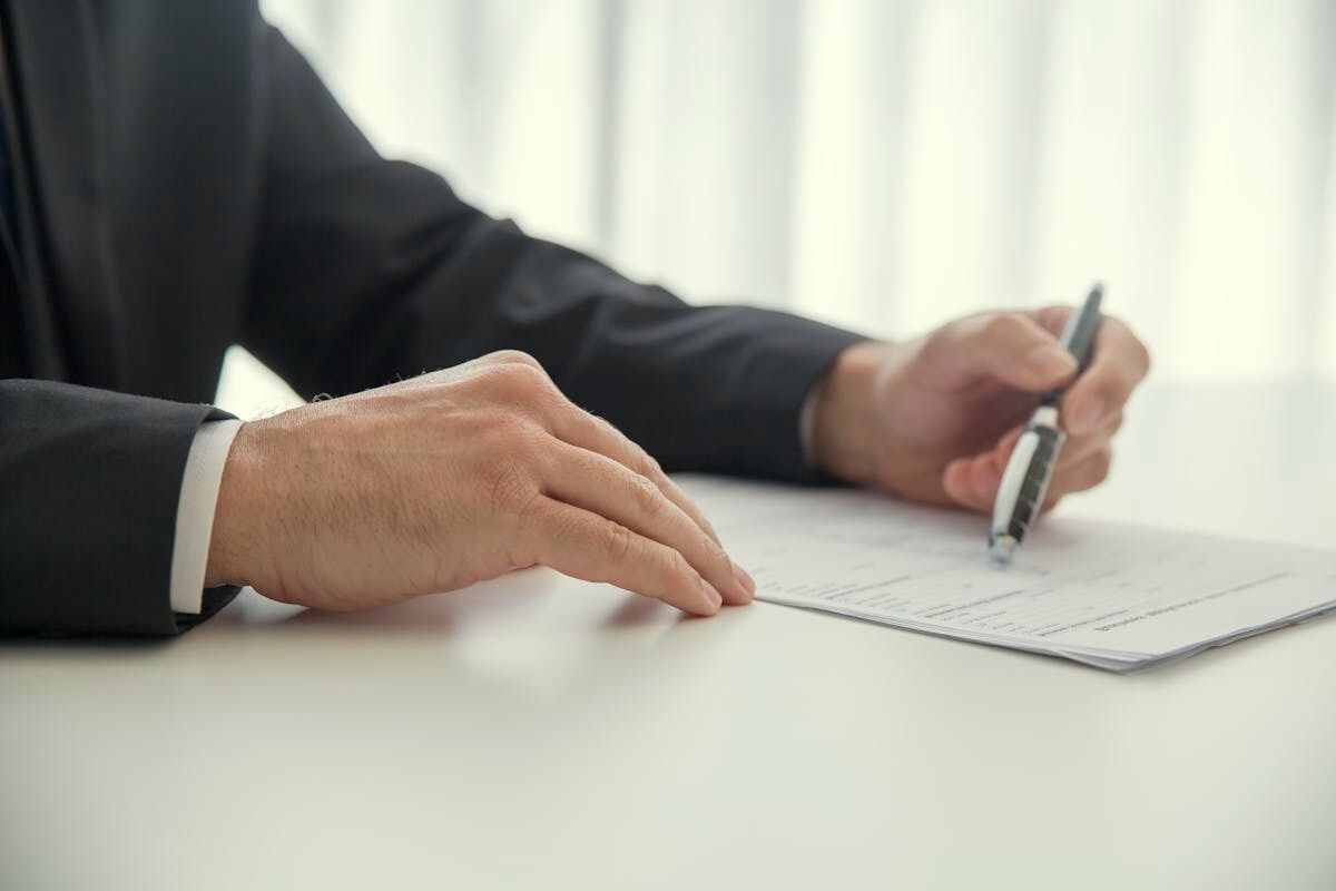Close-up of hands reviewing the four components of an annual report.