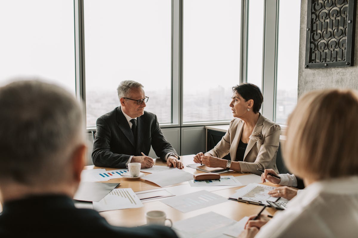 Executives reviewing charts on who must file annual reports.