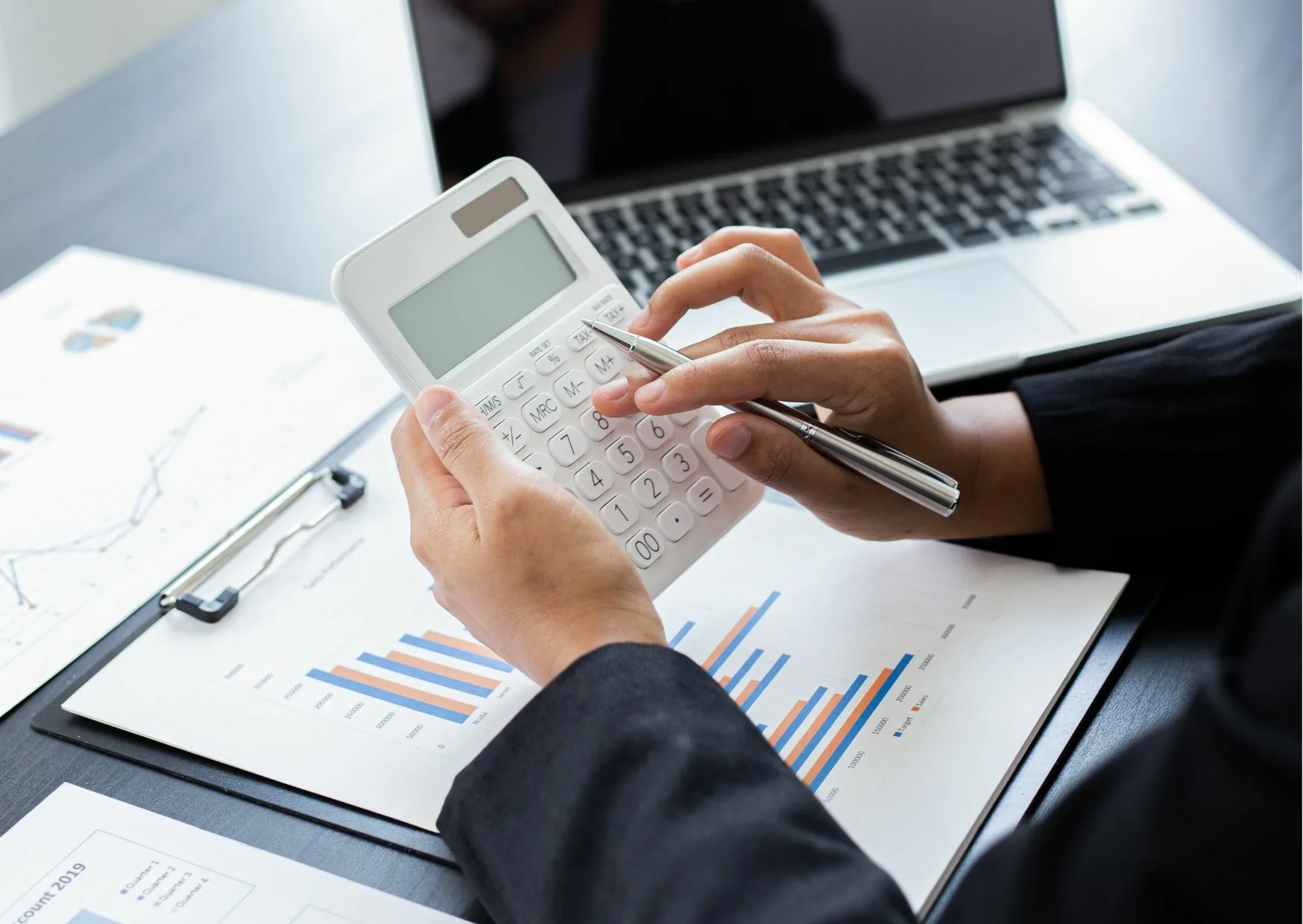 hands using a calculator for cfp services